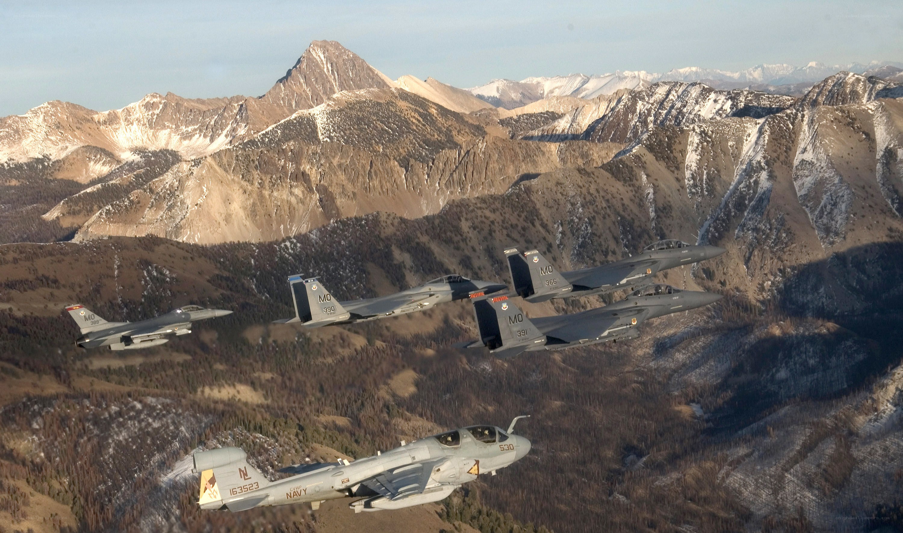 Fighter jets flying over mountains