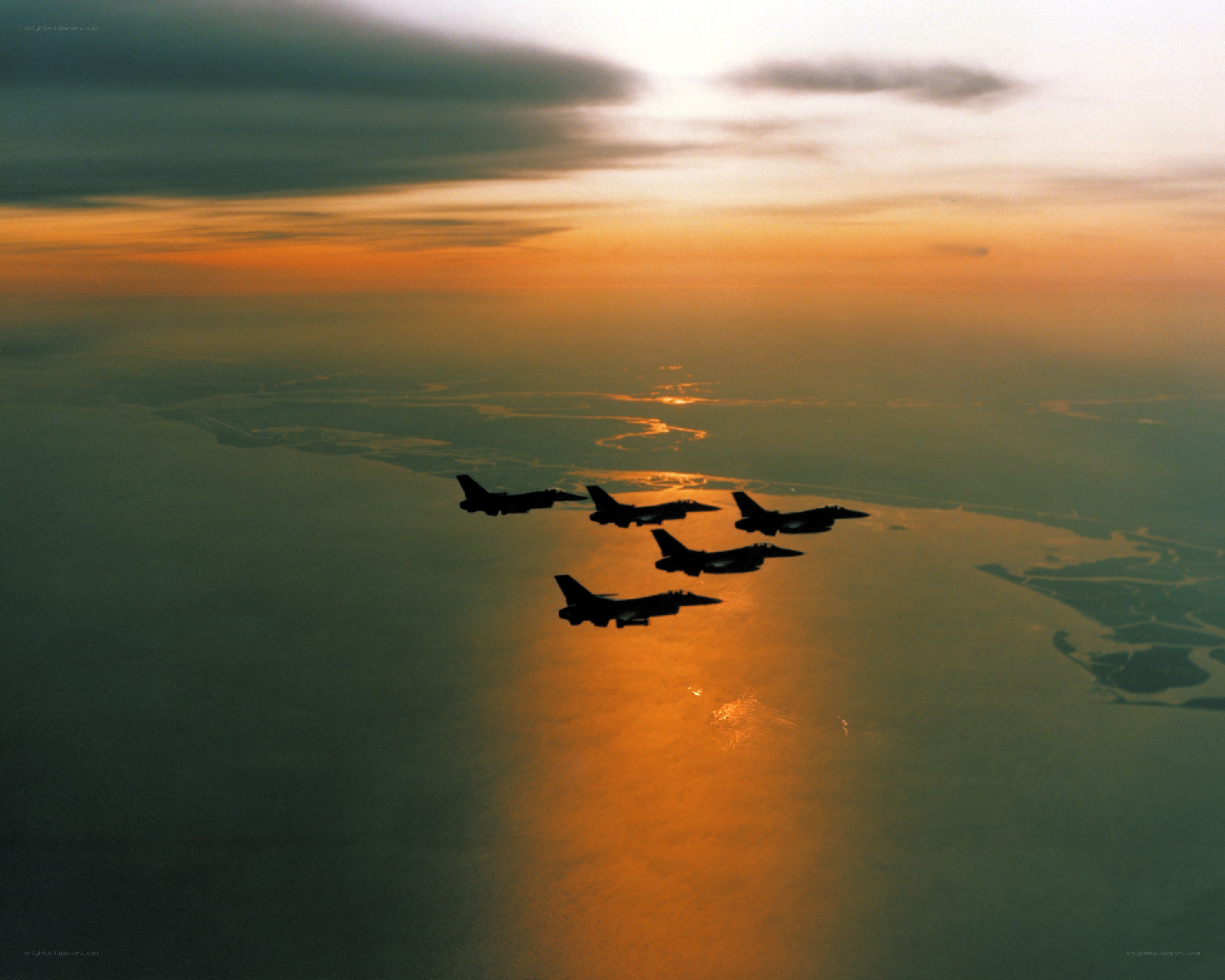 Fighter jets in formation at sunset