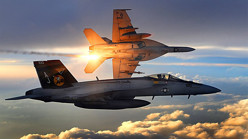 Fighter jets in formation at sunset
