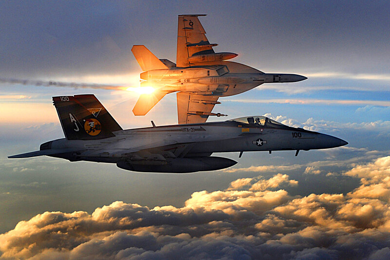 Fighter jets in formation at sunset