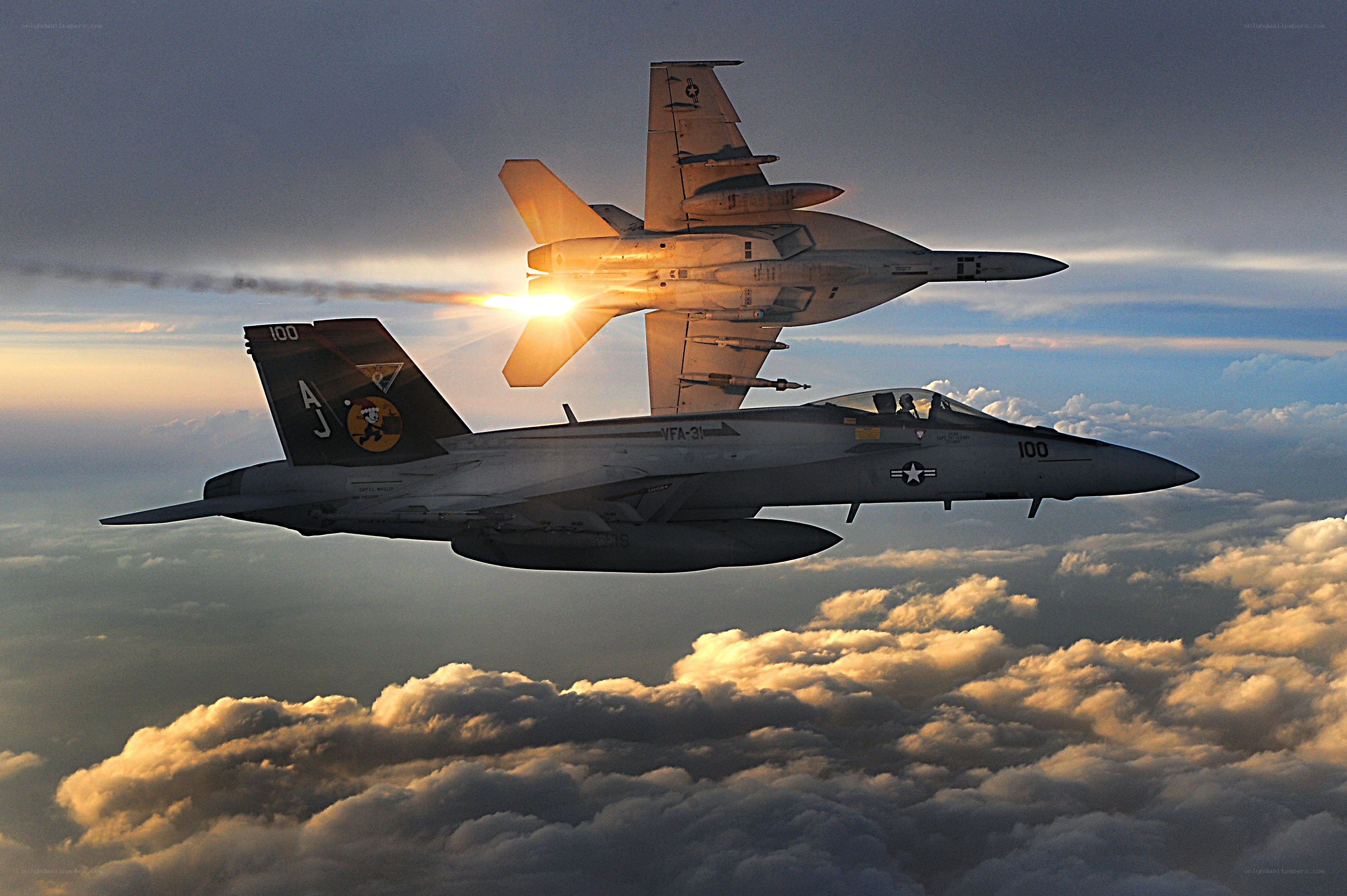 Fighter jets in formation at sunset
