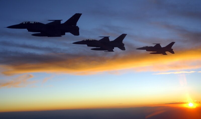 Fighter jets in formation at sunset