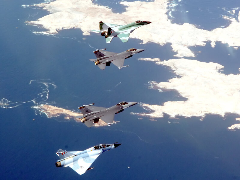 Fighter jets in formation over coast
