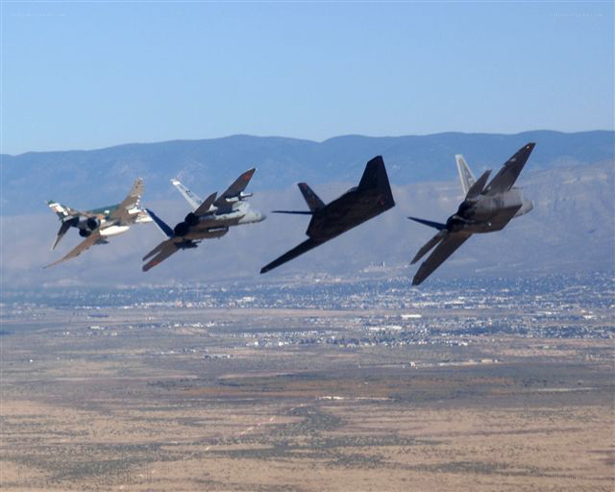 Fighter jets in formation over desert