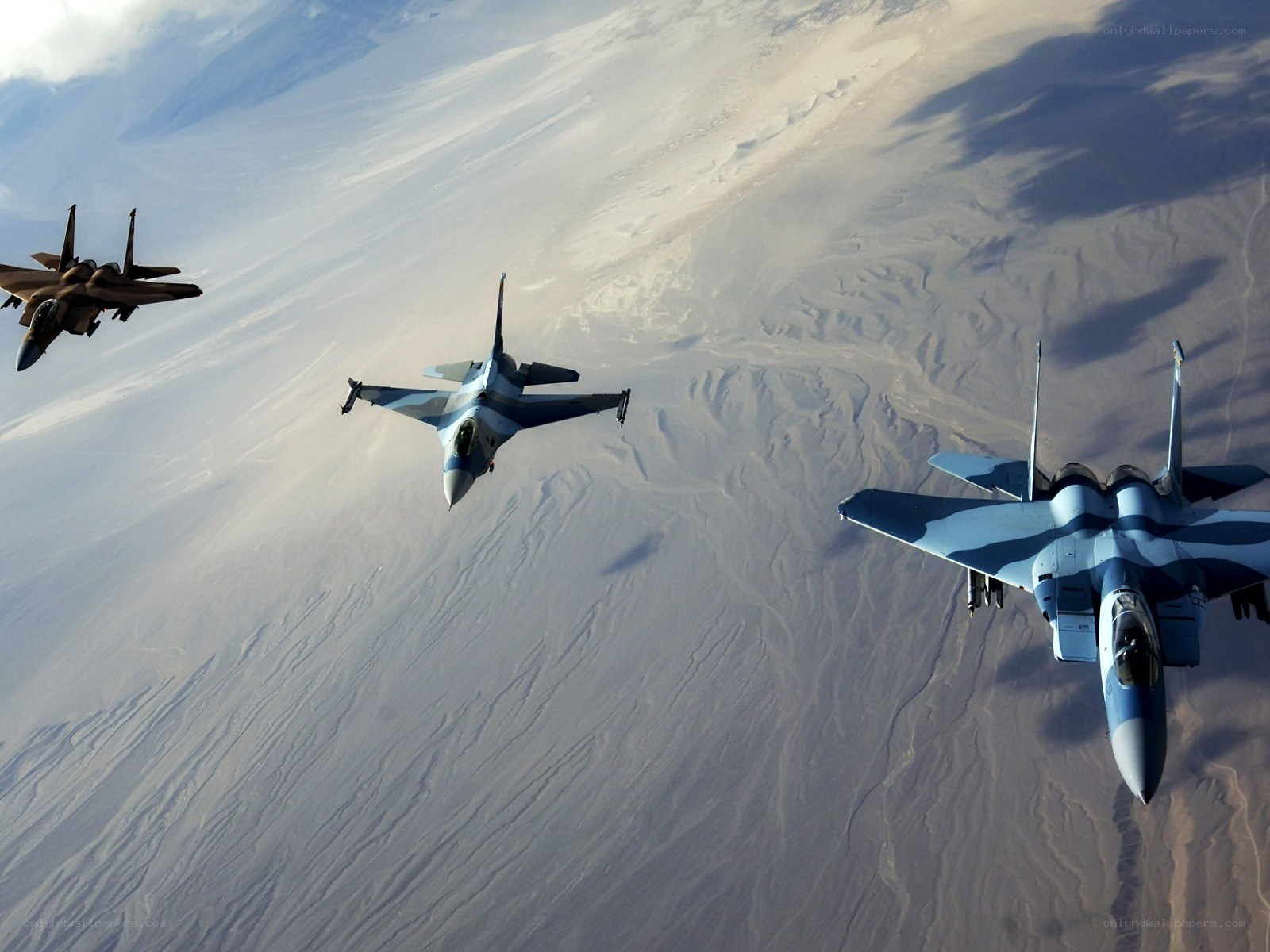 Fighter jets in formation over desert