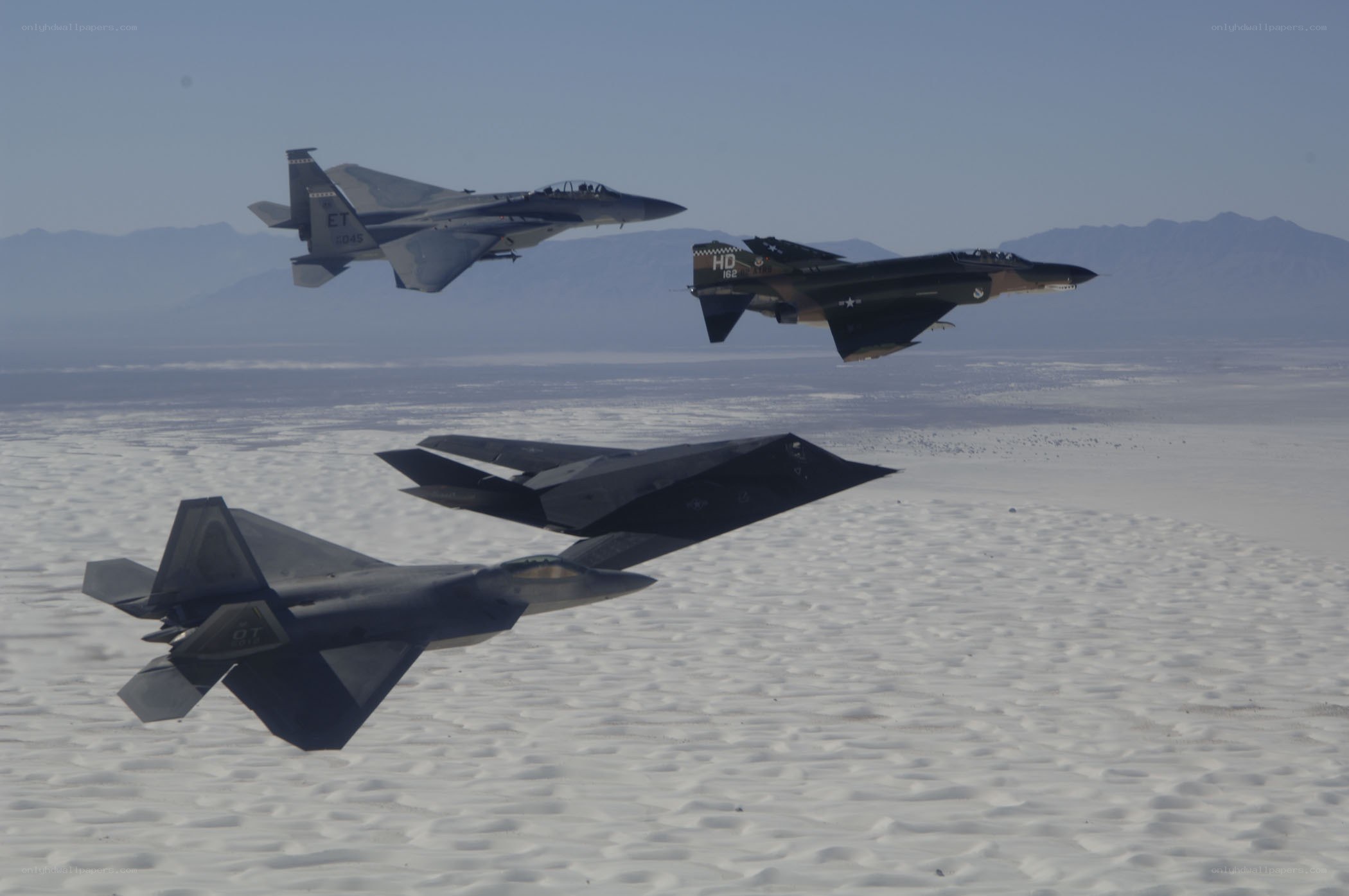 Fighter jets in formation over desert
