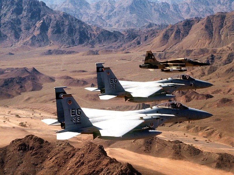 Fighter jets in formation over desert