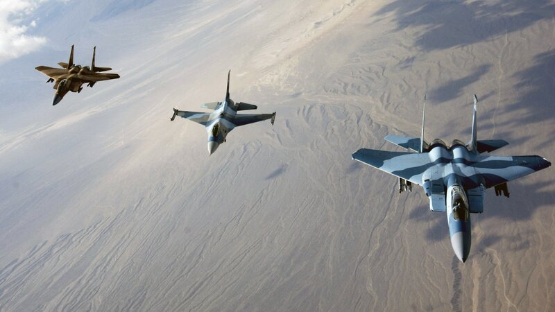 Fighter jets in formation over desert