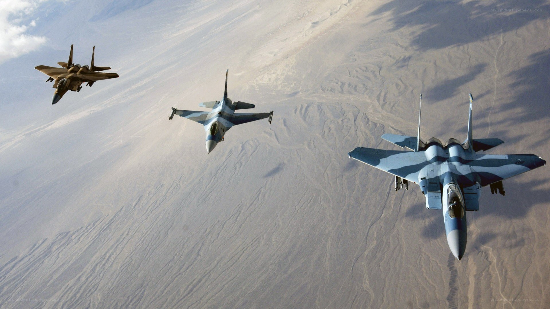 Fighter jets in formation over desert