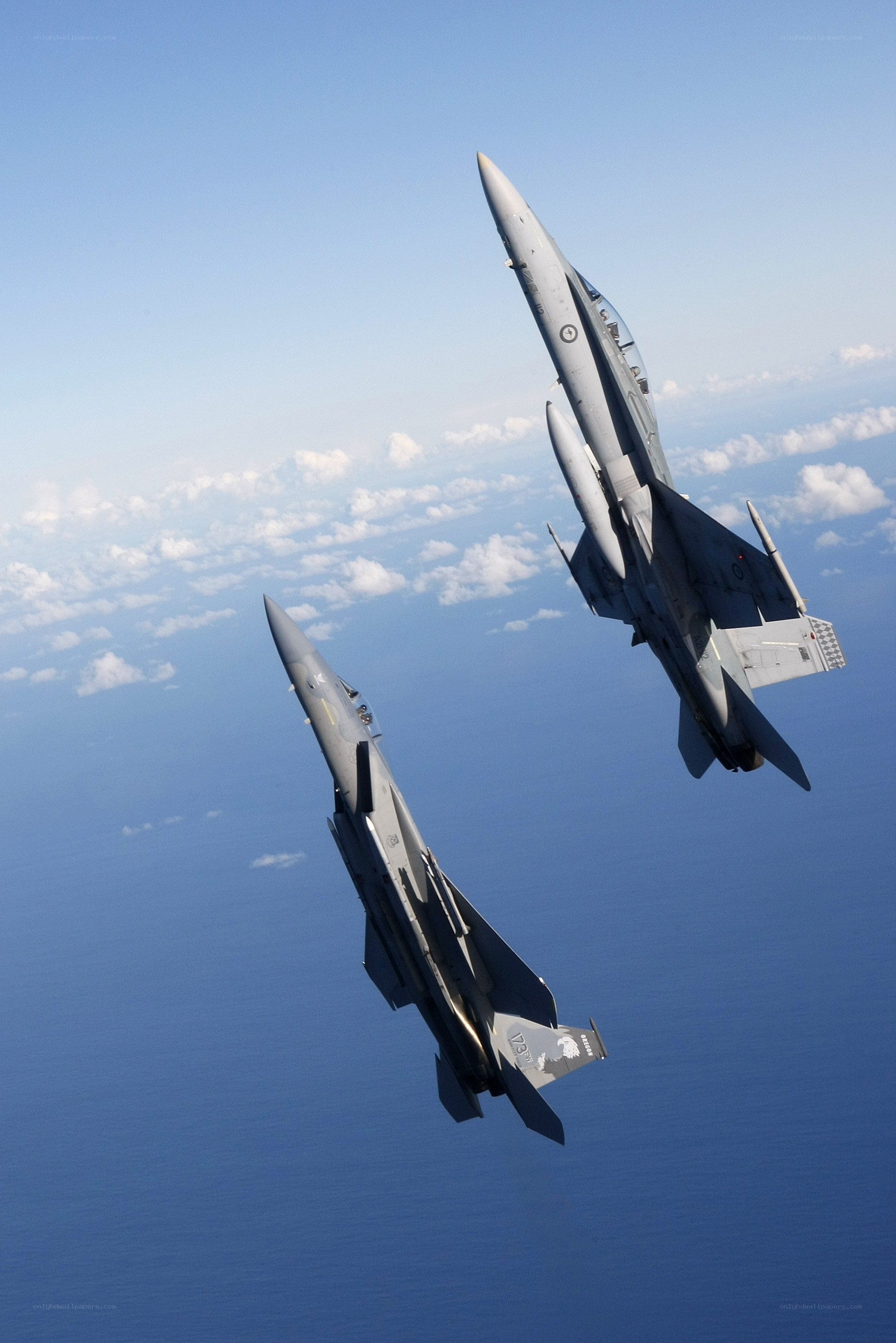 Fighter jets in formation over ocean
