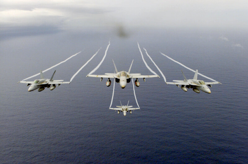 Fighter jets in formation over ocean