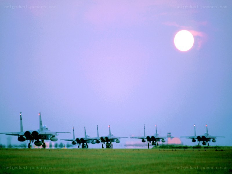 Fighter jets on a runway at dusk