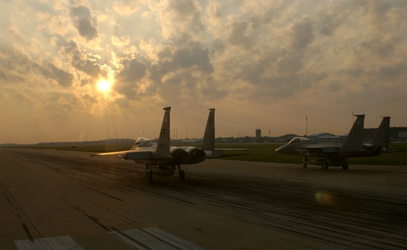 Fighter jets on runway at sunset