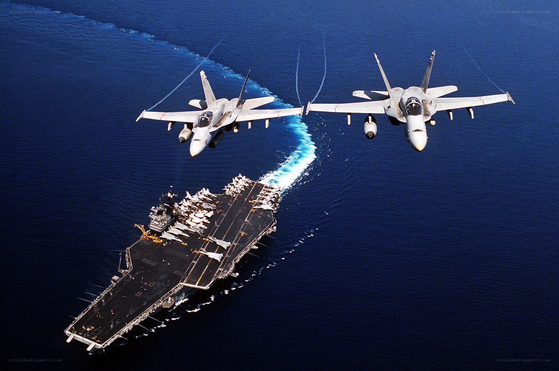 Fighter jets over aircraft carrier