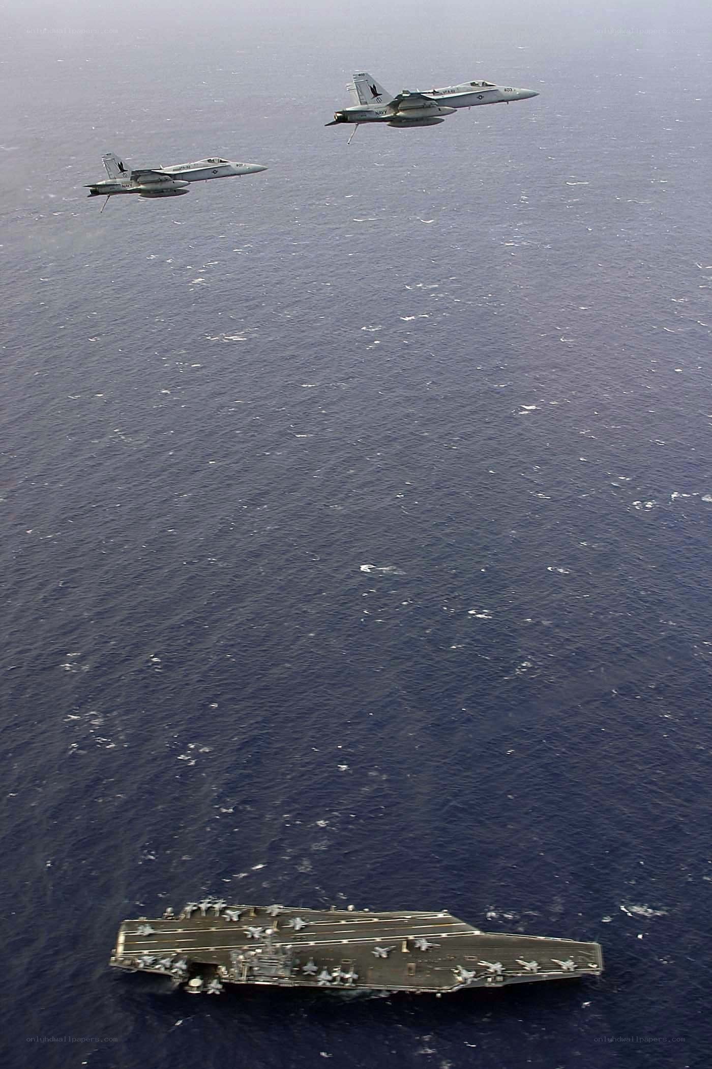 Fighter jets over aircraft carrier