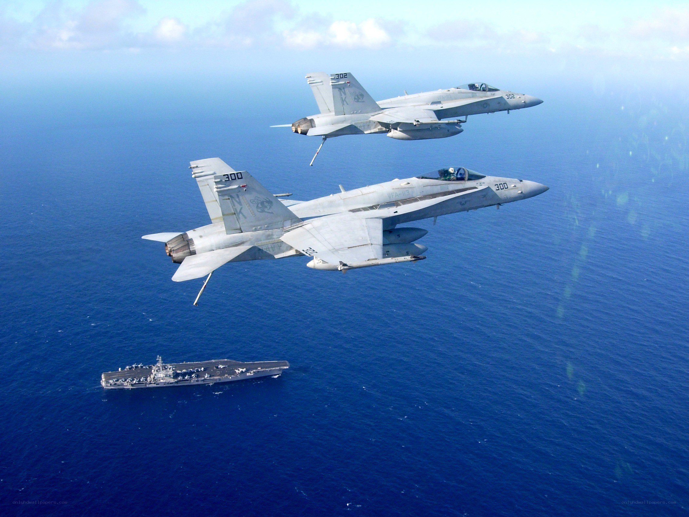 Fighter jets over aircraft carrier