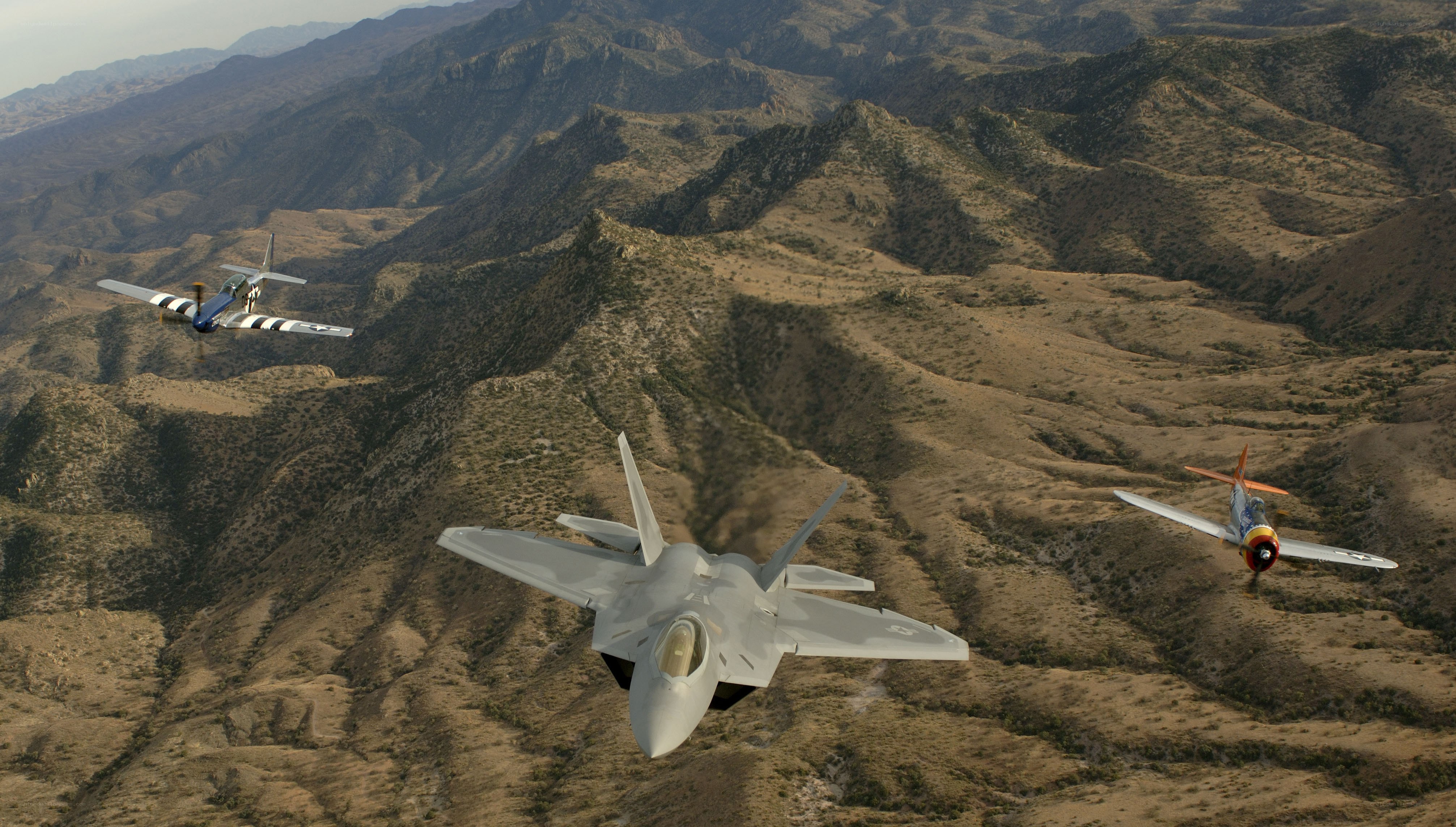Fighter jets over mountainous terrain