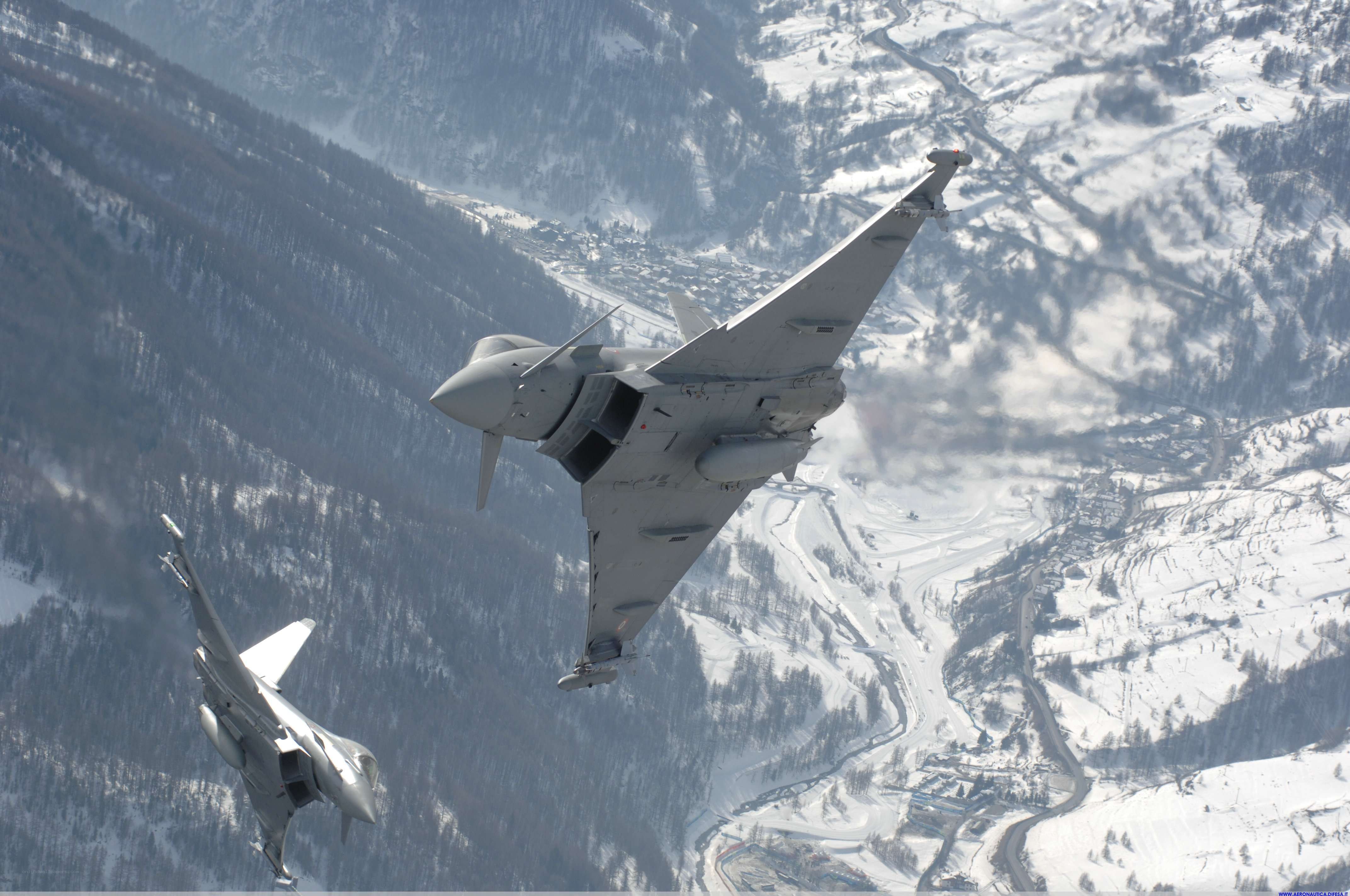Fighter jets over snowy mountains