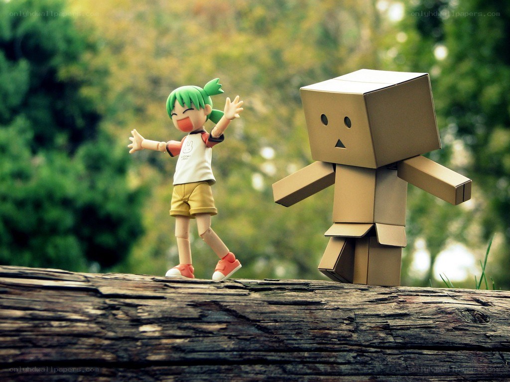 figurine and cardboard robot on log