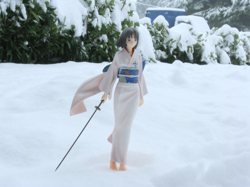 figurine in snowy garden