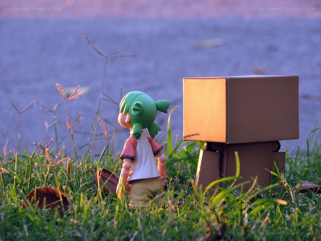 figurines in grass at sunset