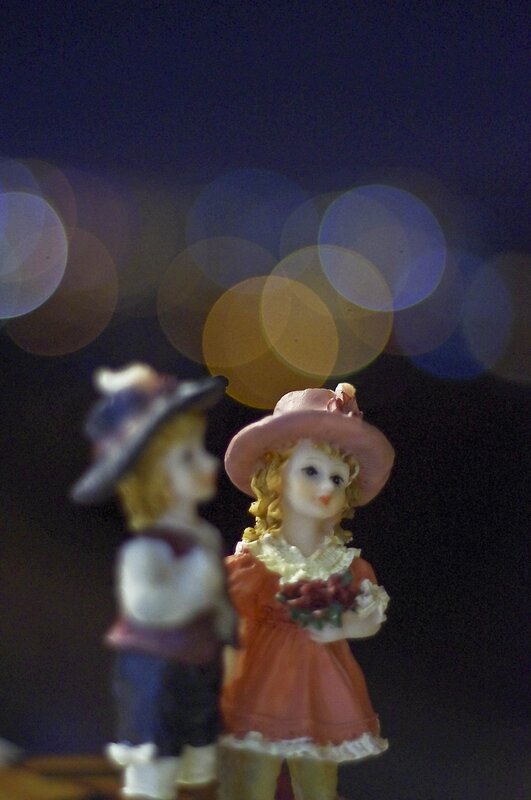 figurines with bokeh lights