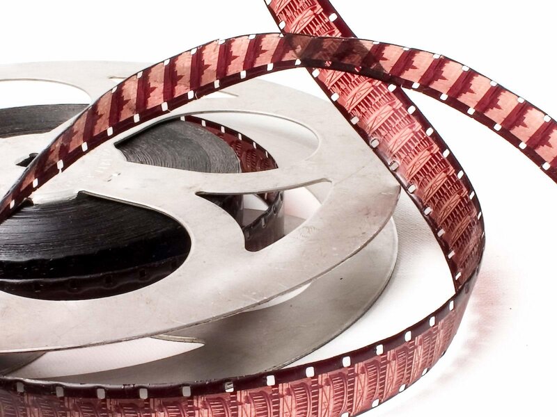 Film reel with red-tinted film strip