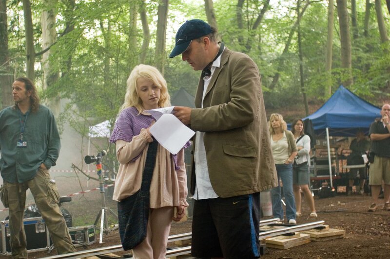 Film set in forest with director and actress