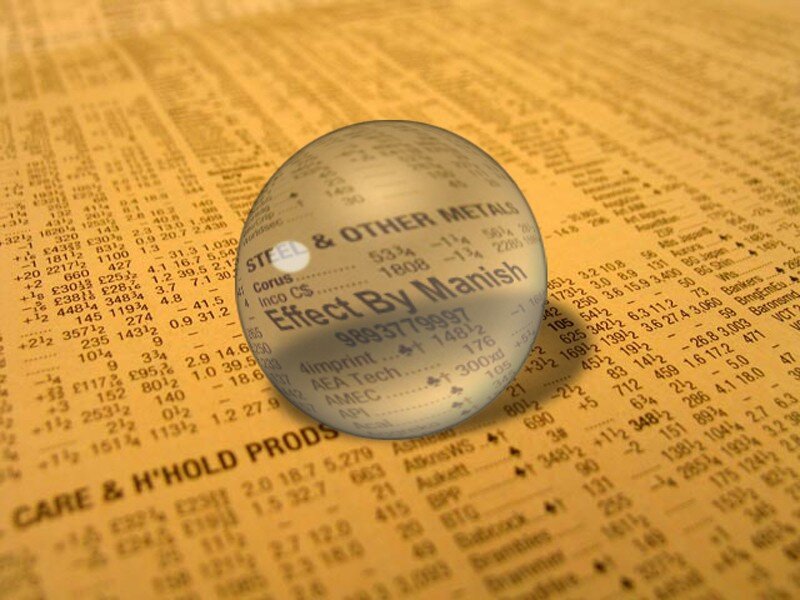 Financial newspaper with glass sphere