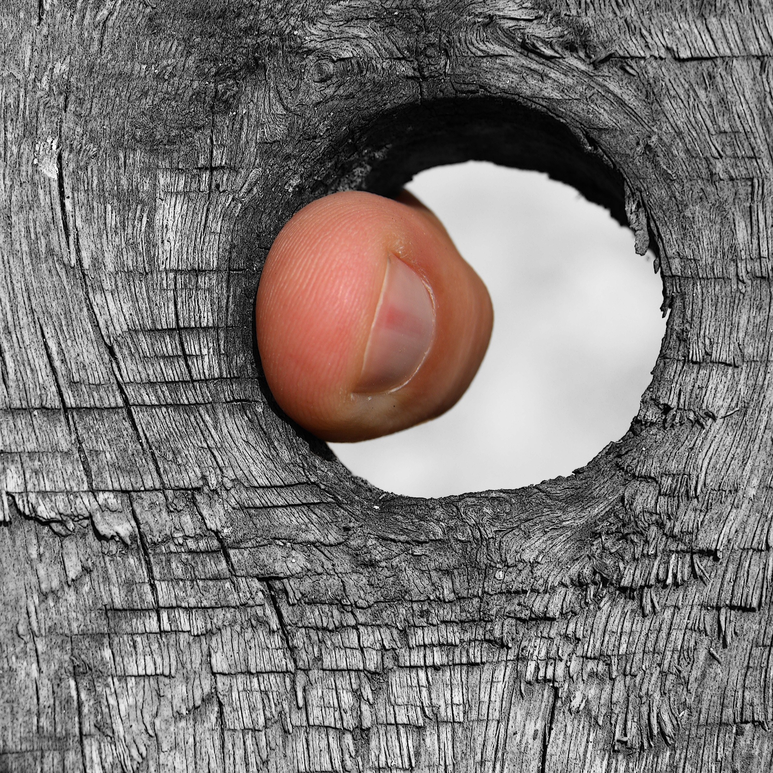 finger through wooden hole