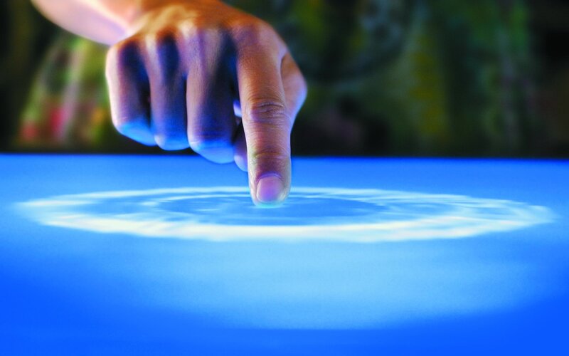 Finger Touching Blue Surface — Dramatic