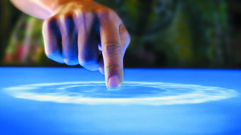 Finger Touching Blue Surface
