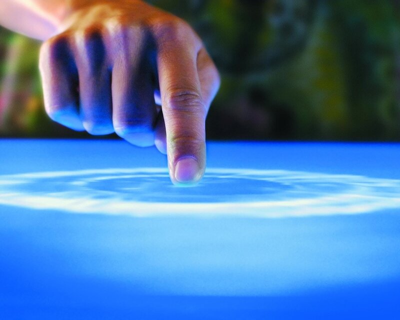 finger touching digital surface