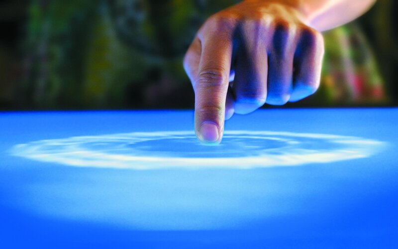 finger touching digital surface