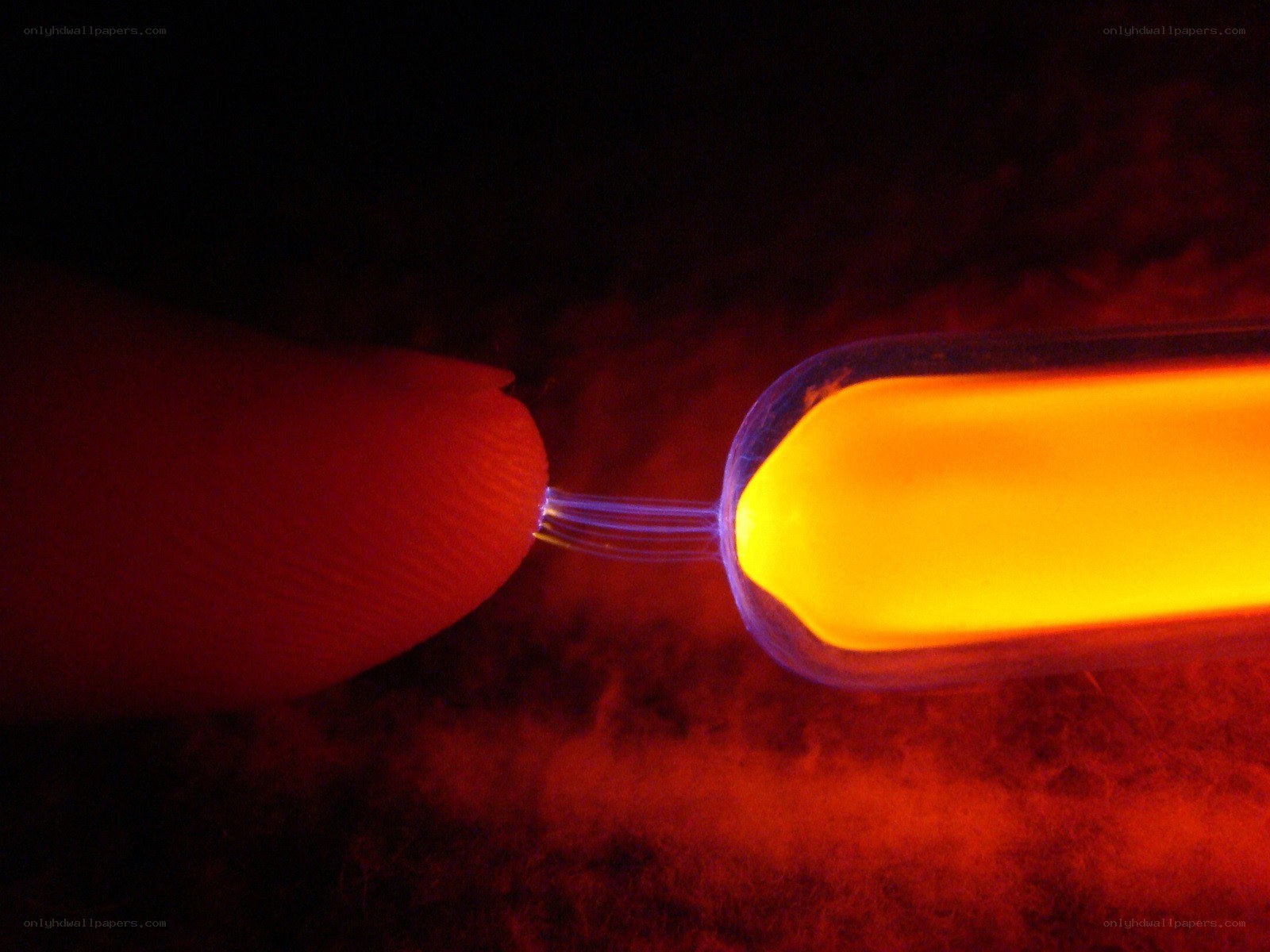 finger touching glowing tube