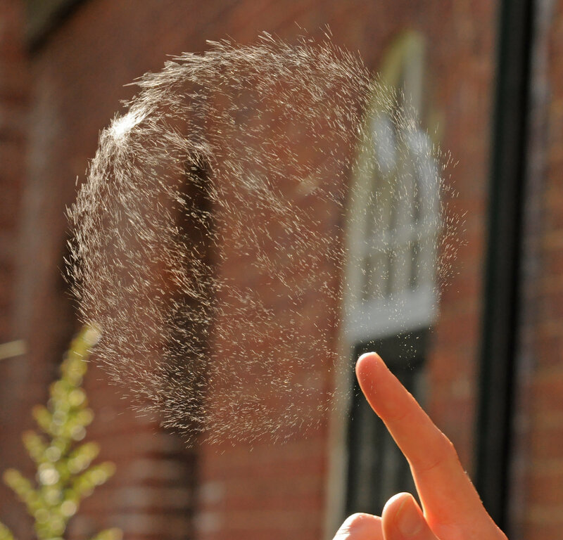 finger touching water spray