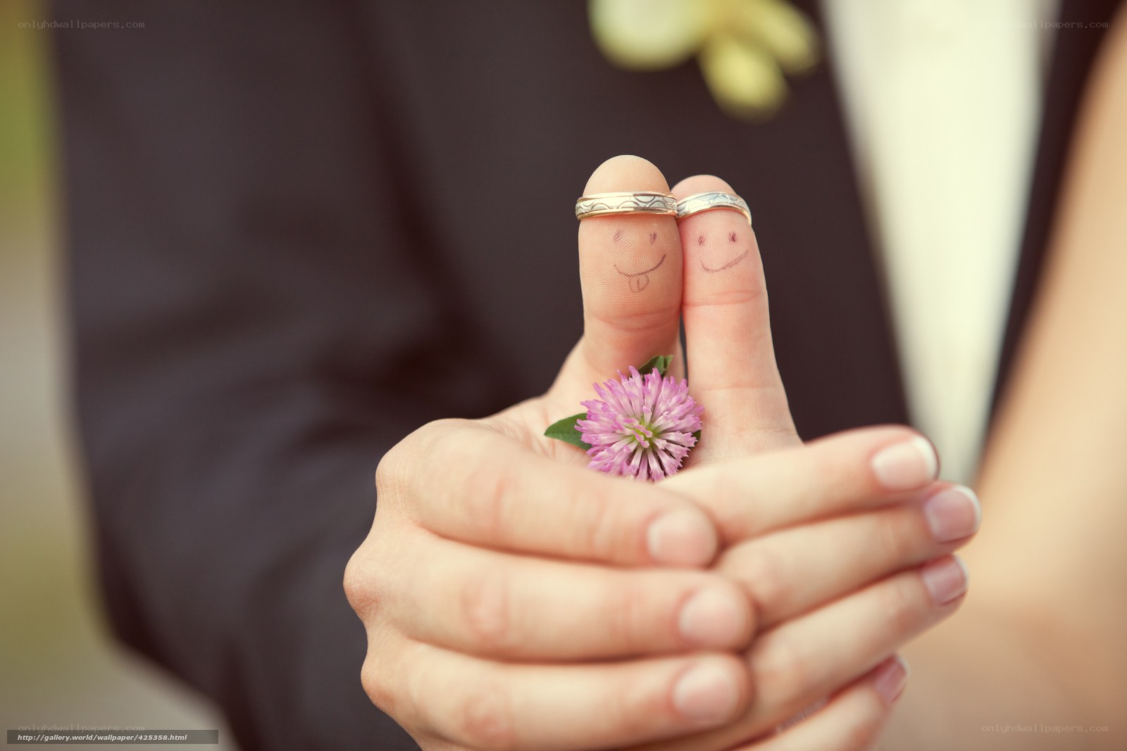Fingers with rings and flower