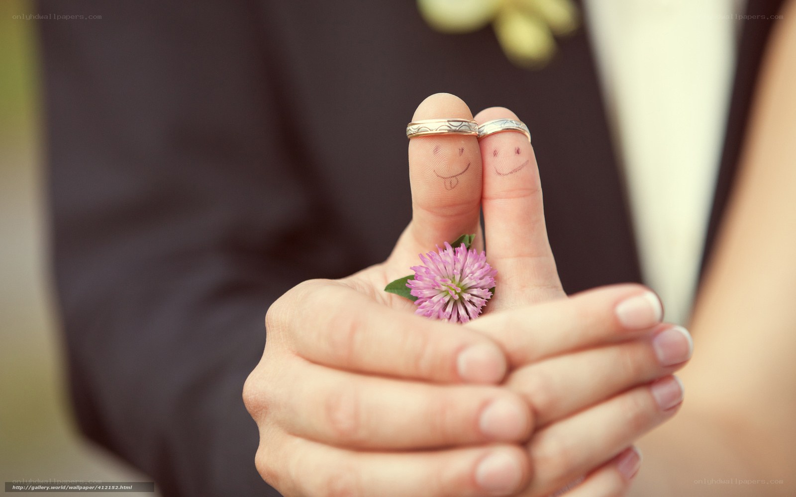 Fingers with rings and flower