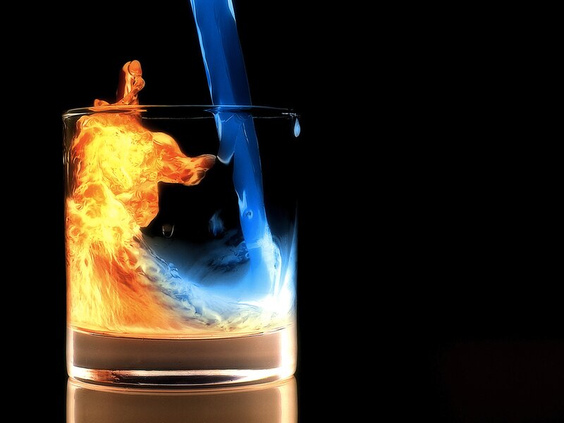 Fire and water pouring into glass