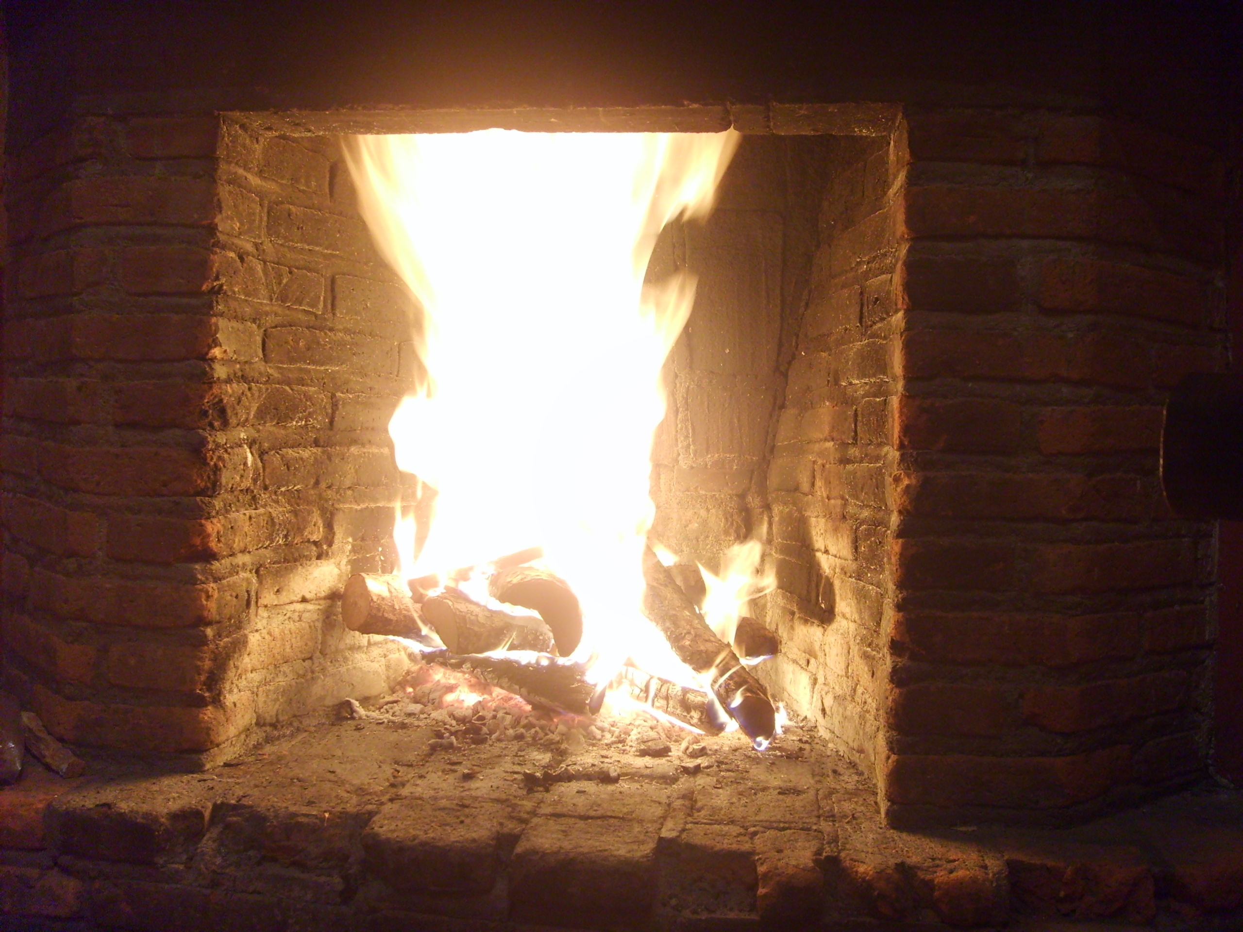 fire burning in a brick fireplace