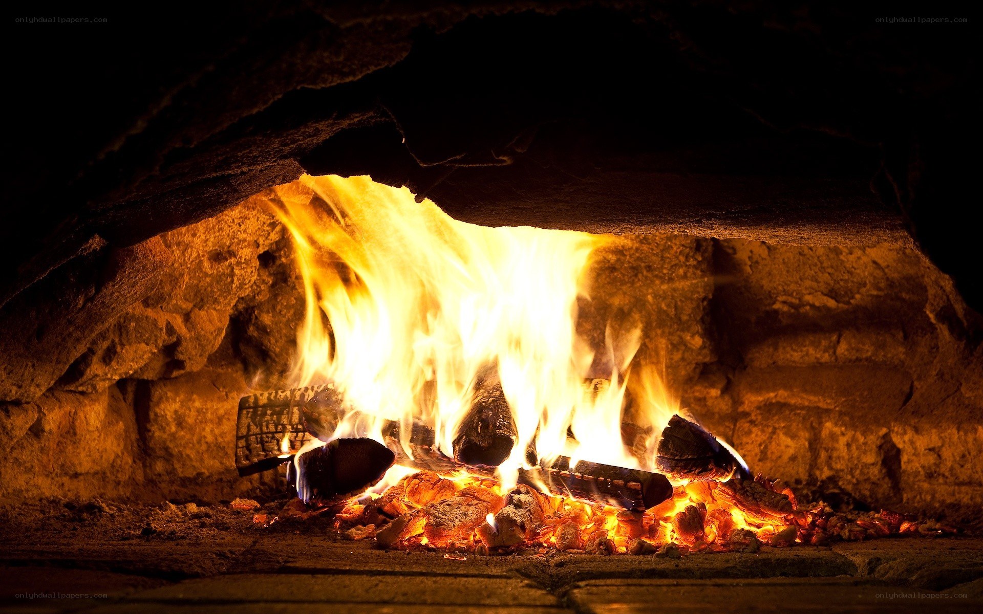 fire burning in a stone fireplace