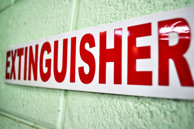 fire extinguisher sign on wall