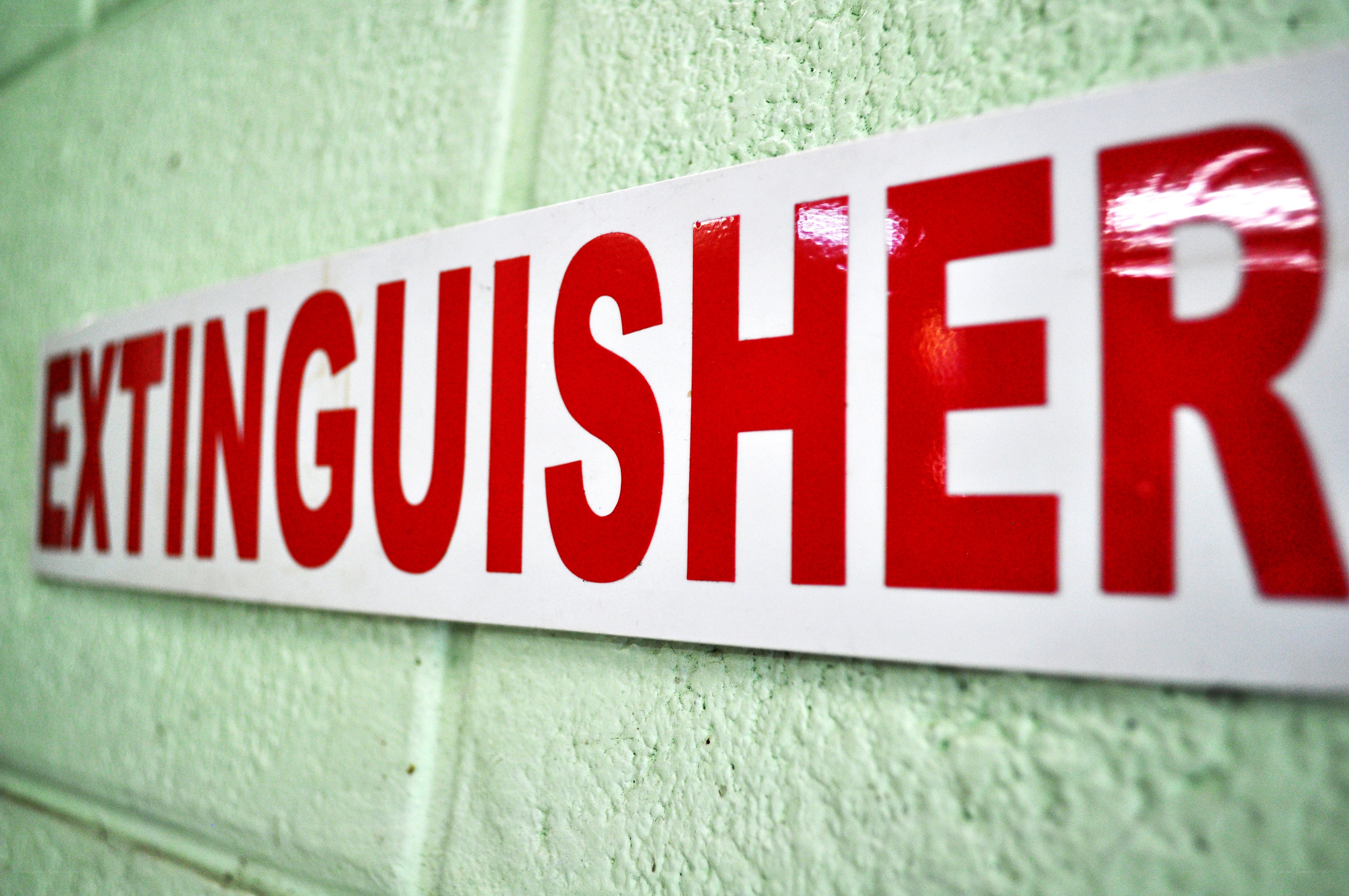 fire extinguisher sign on wall
