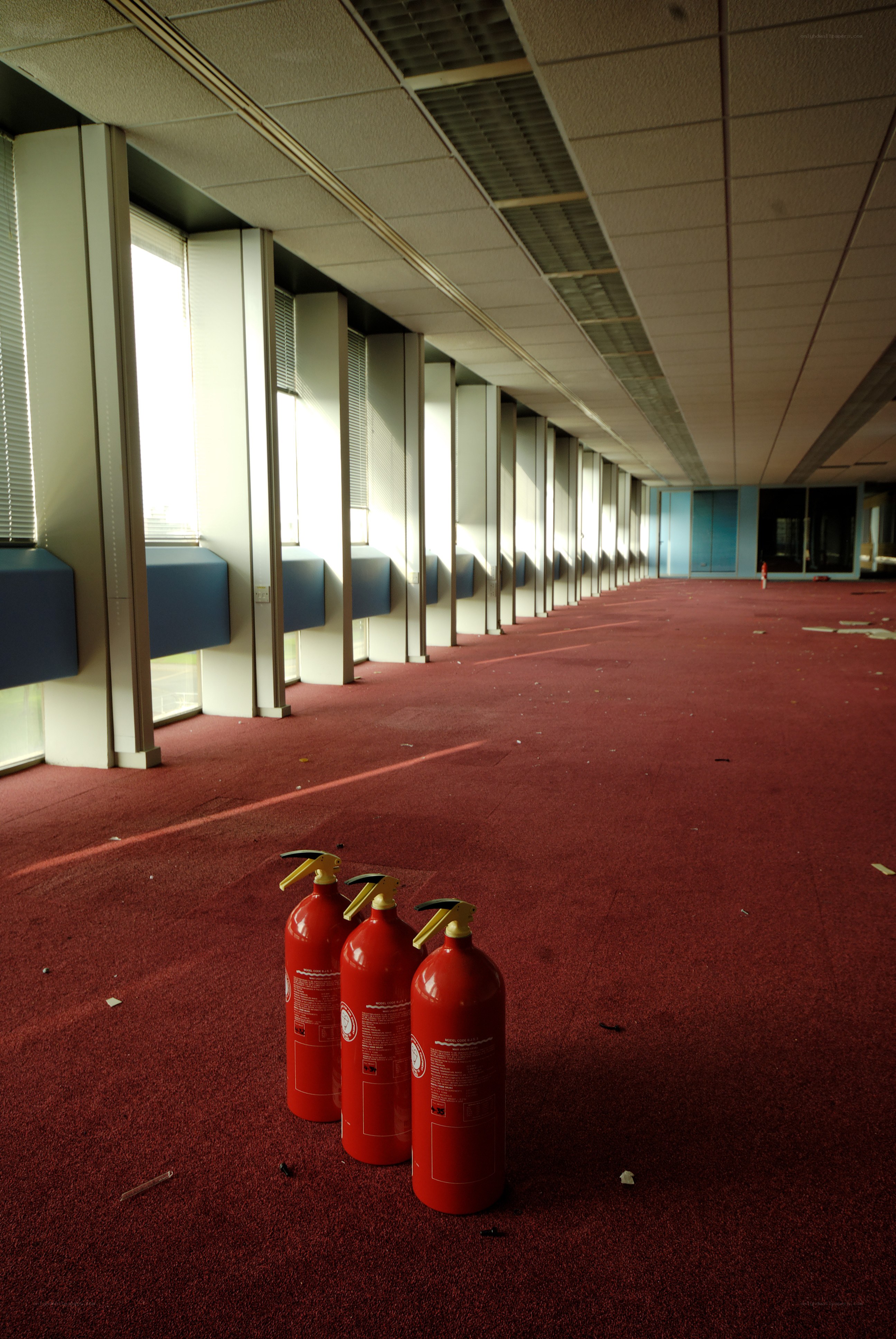 Fire extinguishers in an empty hallway