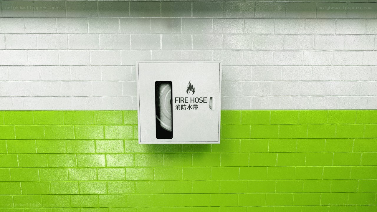 Fire hose cabinet on tiled wall
