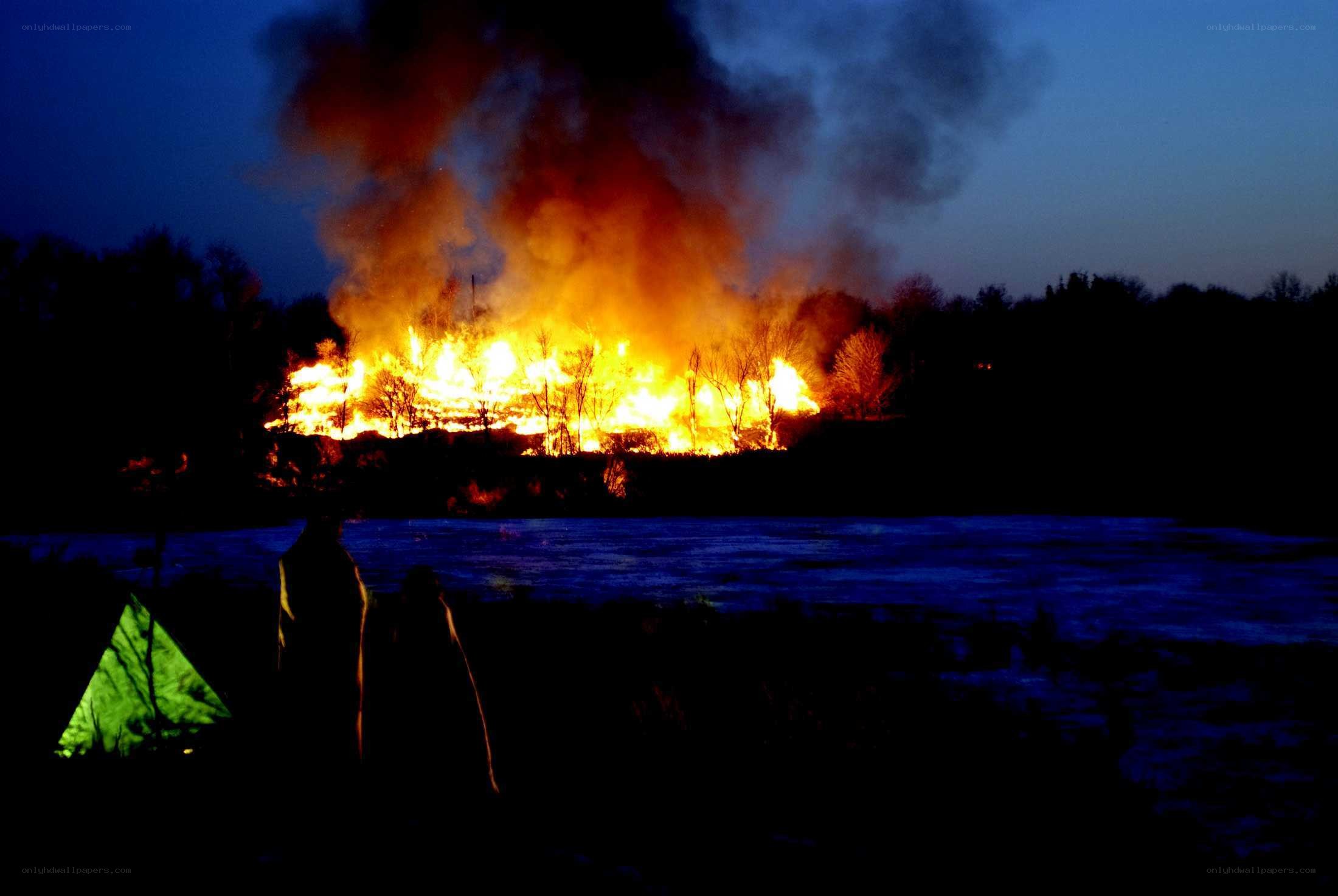 Fire on a riverbank at night