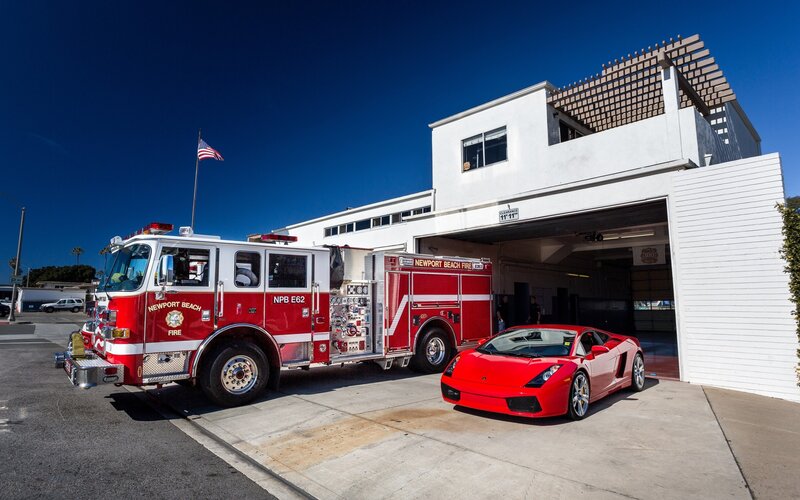 Fire truck and sports car at station