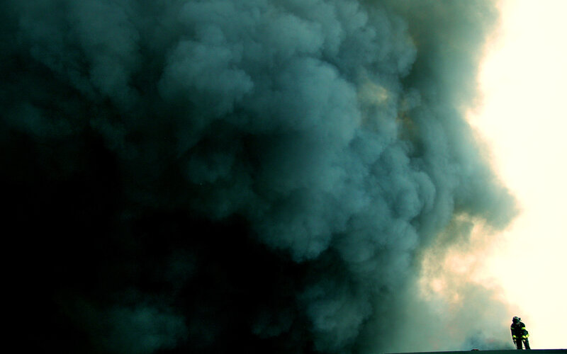 Firefighter facing thick smoke
