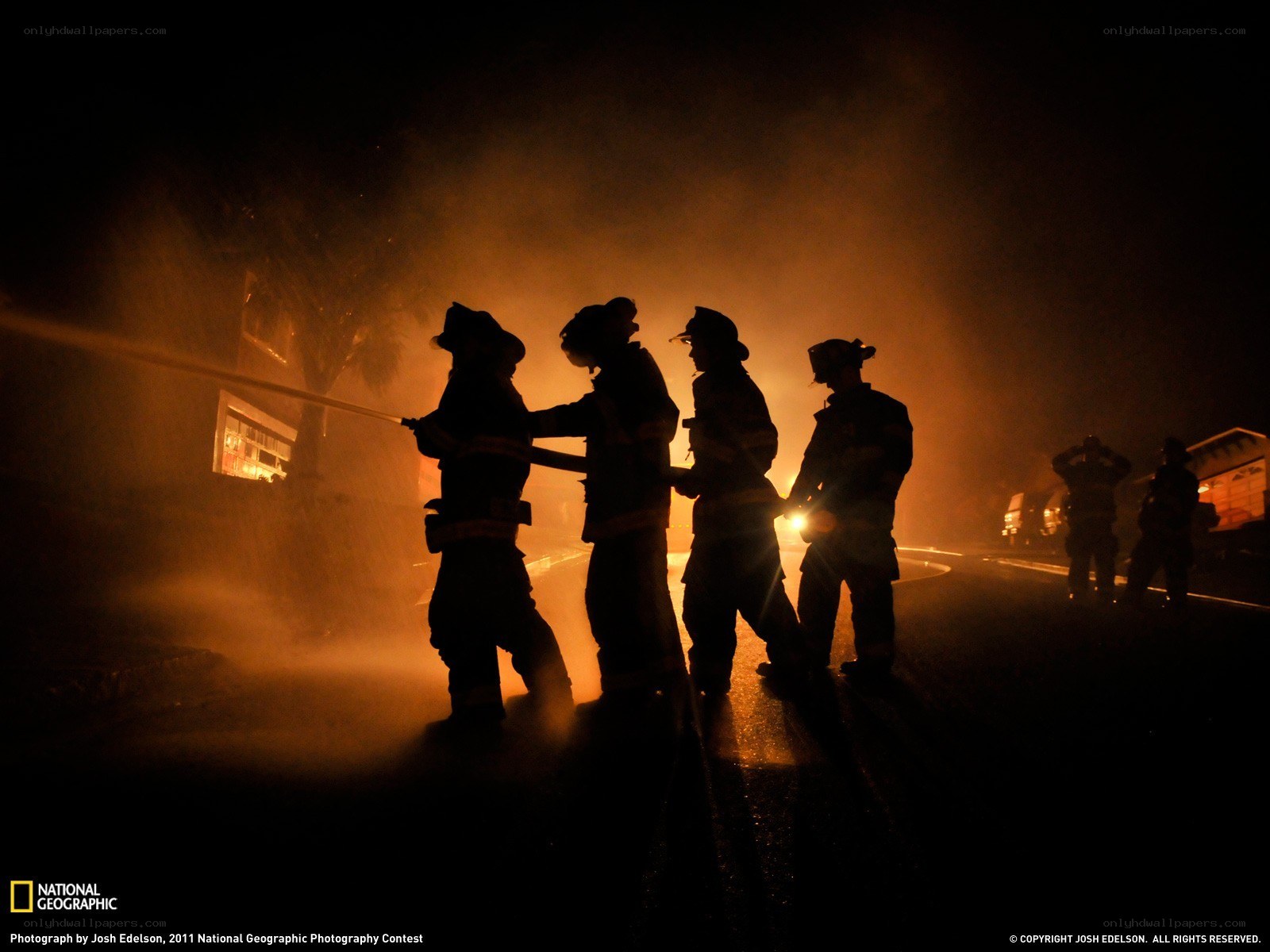 Firefighters battling a blaze at night