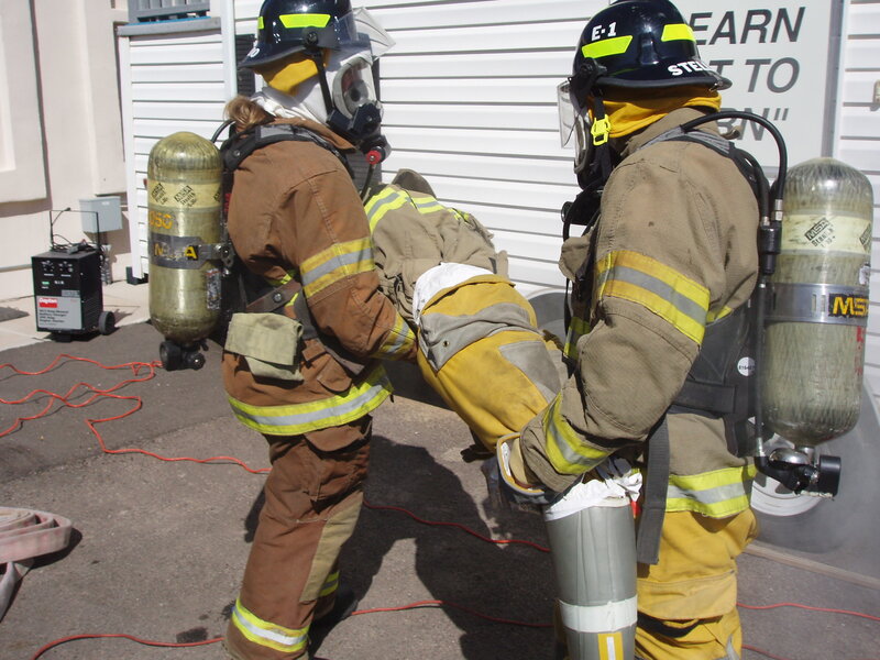 Firefighters carrying a victim